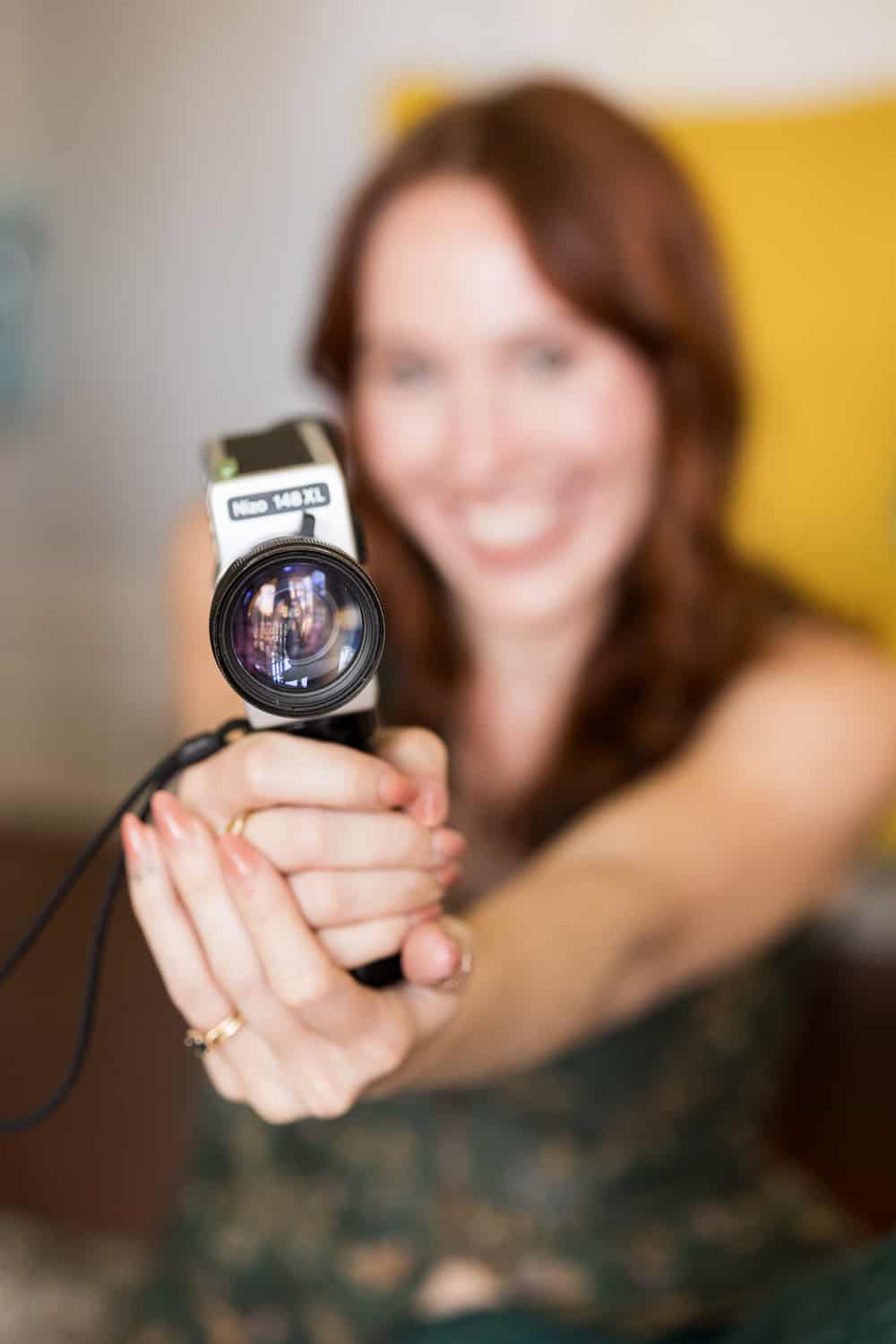Ken holding her film camera towards you